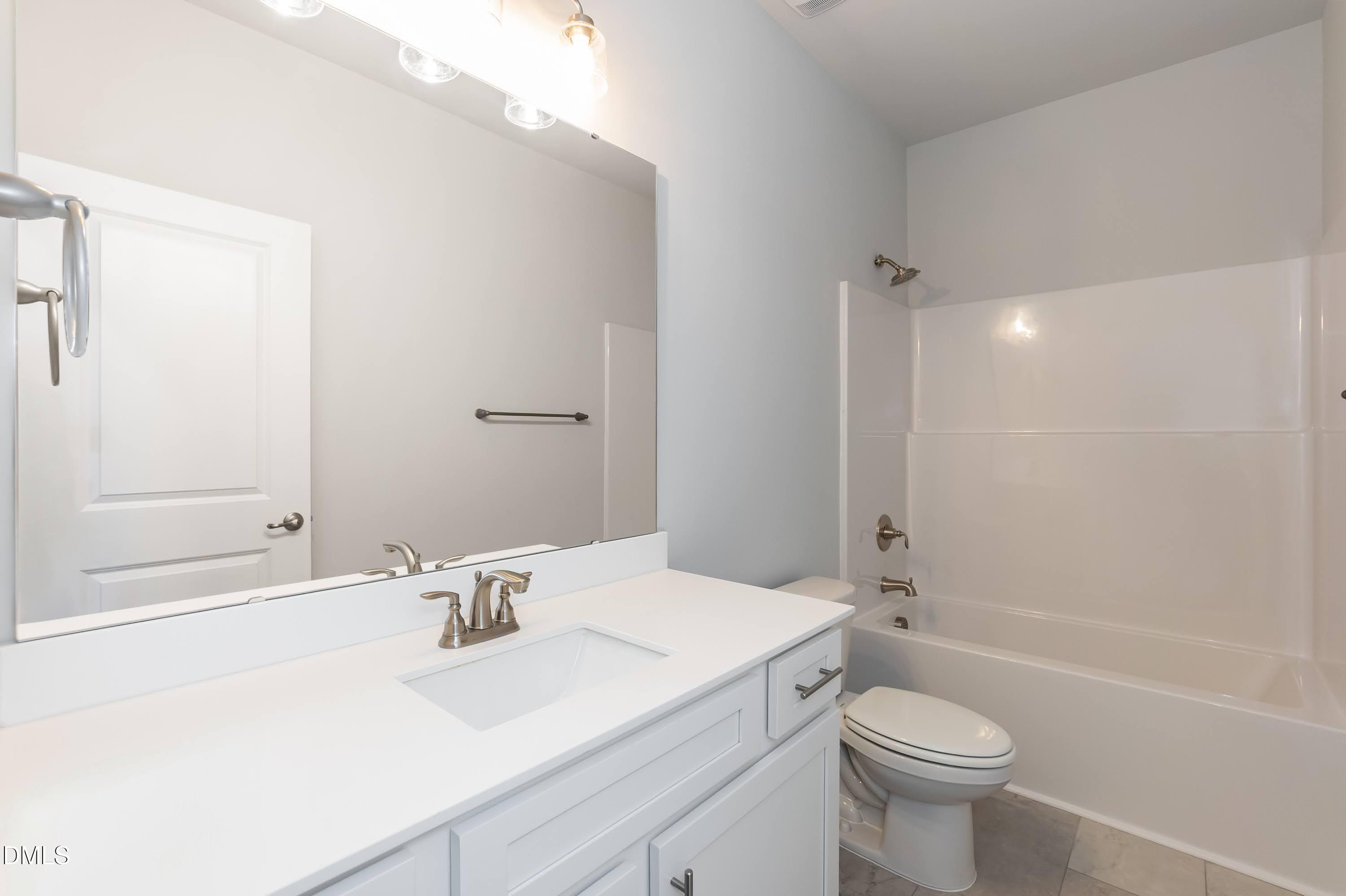 49 Galway Road Lillington, NC 27546 - Photo 30 of 39 a bathroom with a sink a toilet and shower