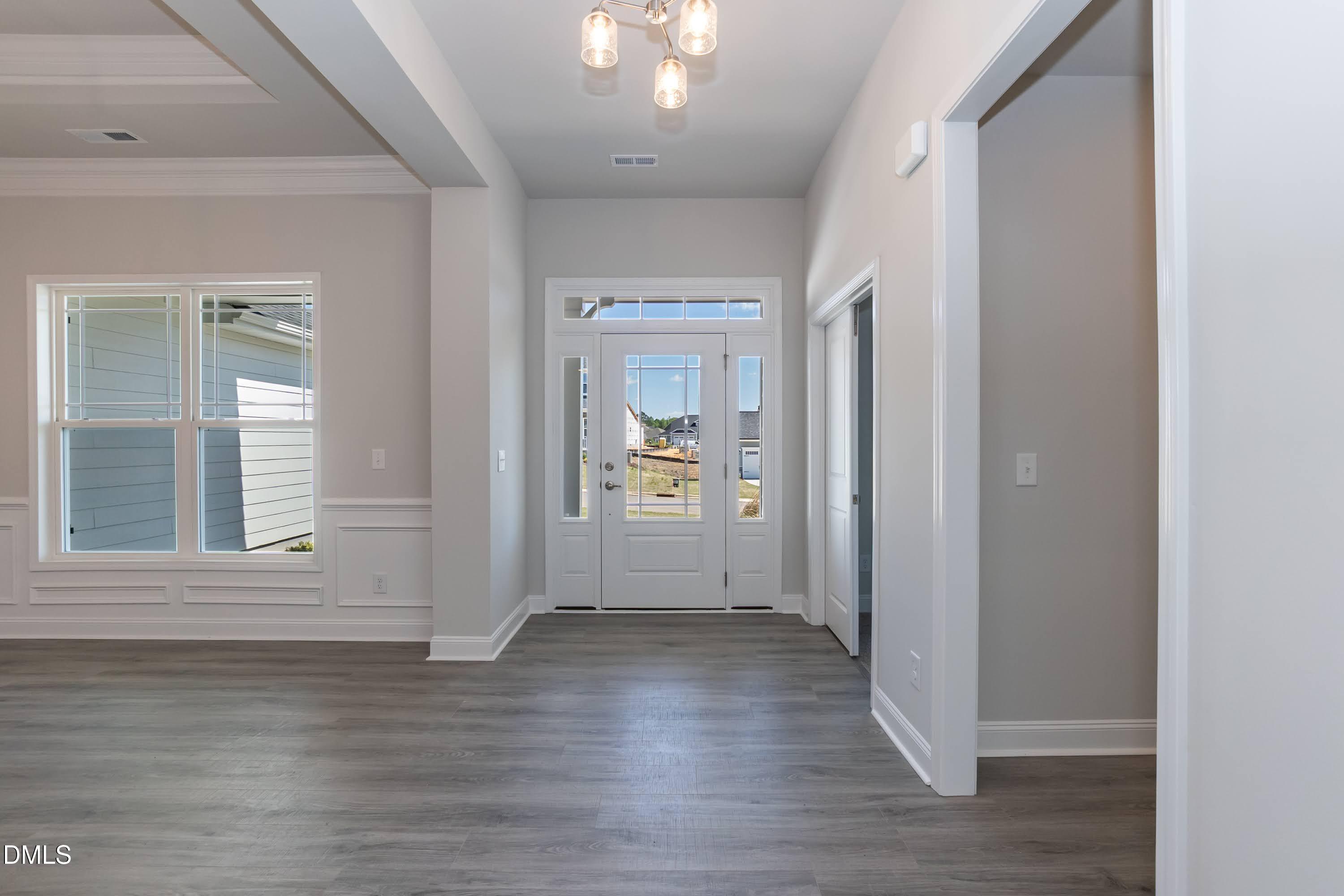49 Galway Road Lillington, NC 27546 - Photo 4 of 39 a view of an empty room with wooden floor and a window