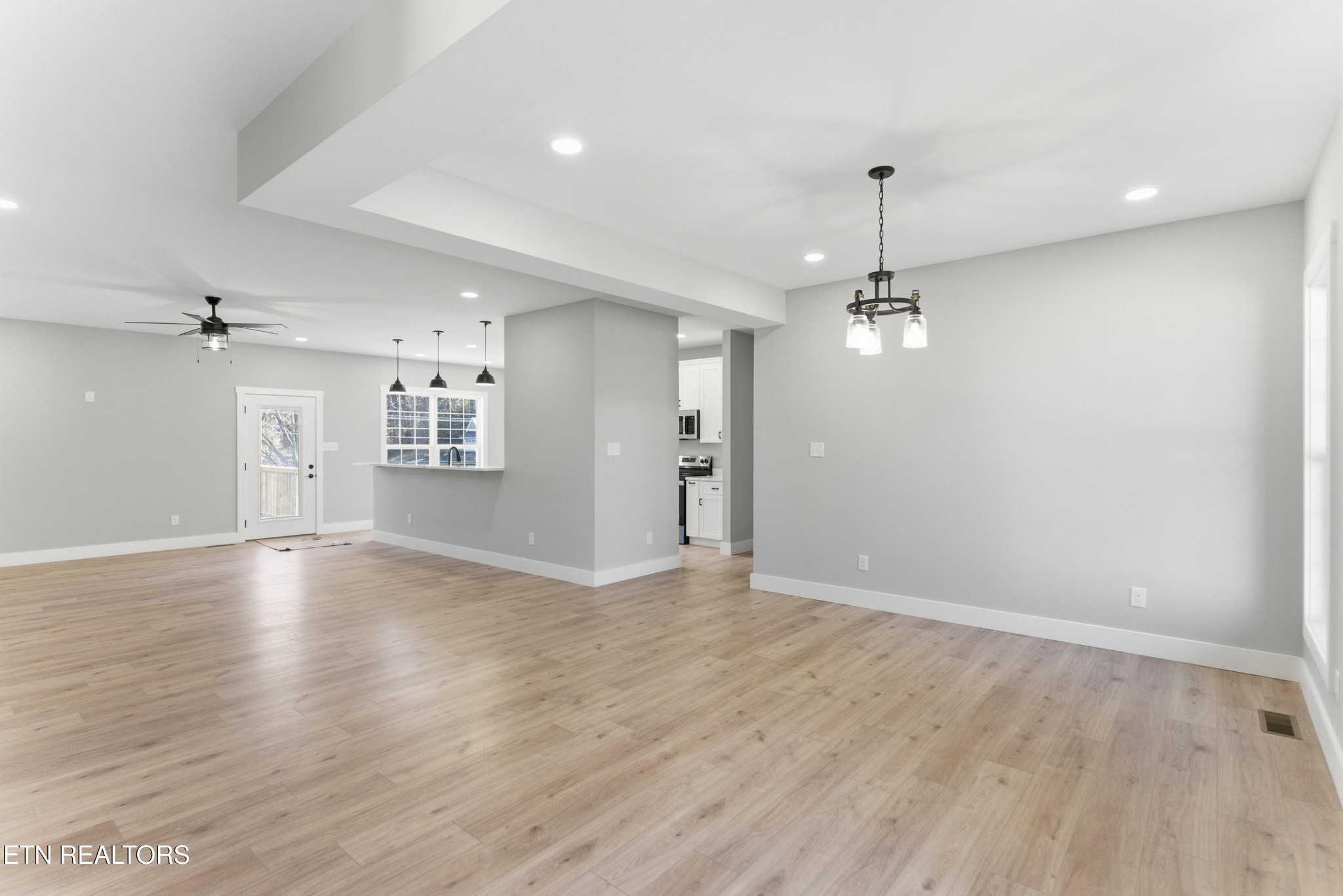 153 Washita Lane Rutledge, TN 37861 - Photo 7 of 44 an empty room with wooden floor chandelier and windows