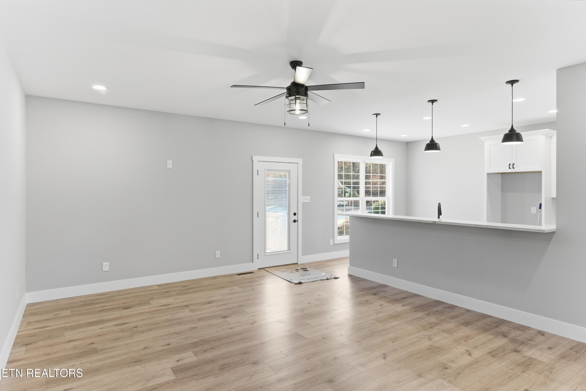 153 Washita Lane Rutledge, TN 37861 - Photo 9 of 44 an empty room with wooden floor and windows