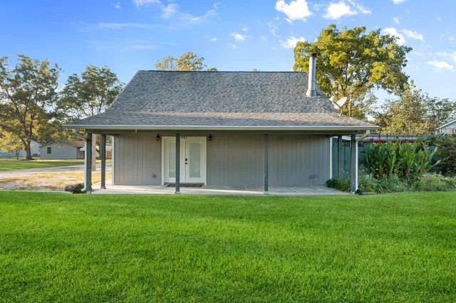 a view of a house with a yard and a garden