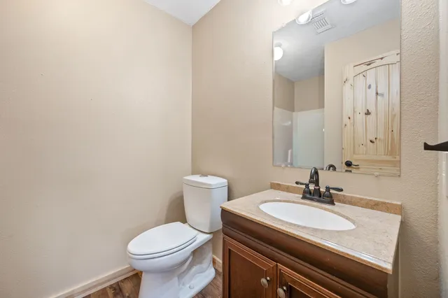 a bathroom with a sink toilet and a mirror