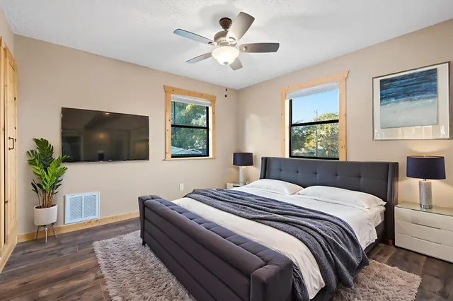 a bedroom with a large bed and a chandelier