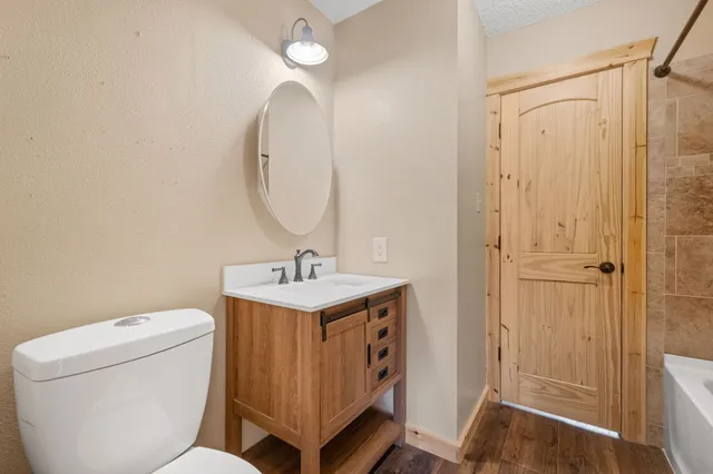 a bathroom with a toilet a sink and a mirror