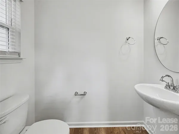 a bathroom with a sink and mirror with toilet