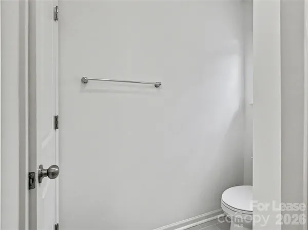 a white toilet sitting next to a shower