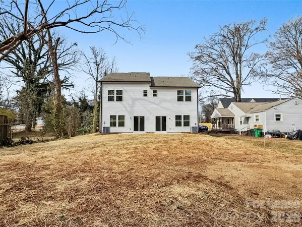 a front view of a house with a yard covered in snow