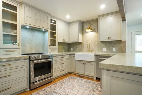 a kitchen with a stove oven and cabinets