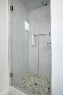 a bathroom with a granite countertop toilet sink and mirror
