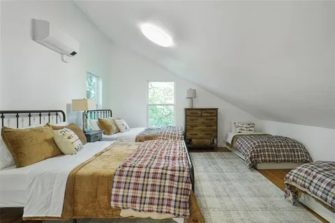 a bedroom with a bed and a couch