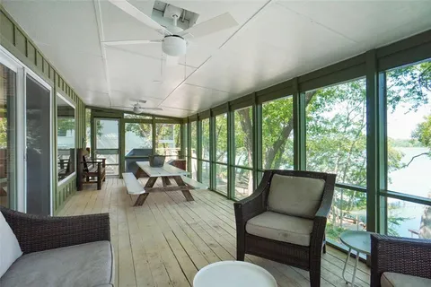 a living room with large windows and wooden floor