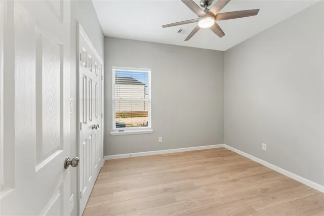 wooden floor in an empty room with a window