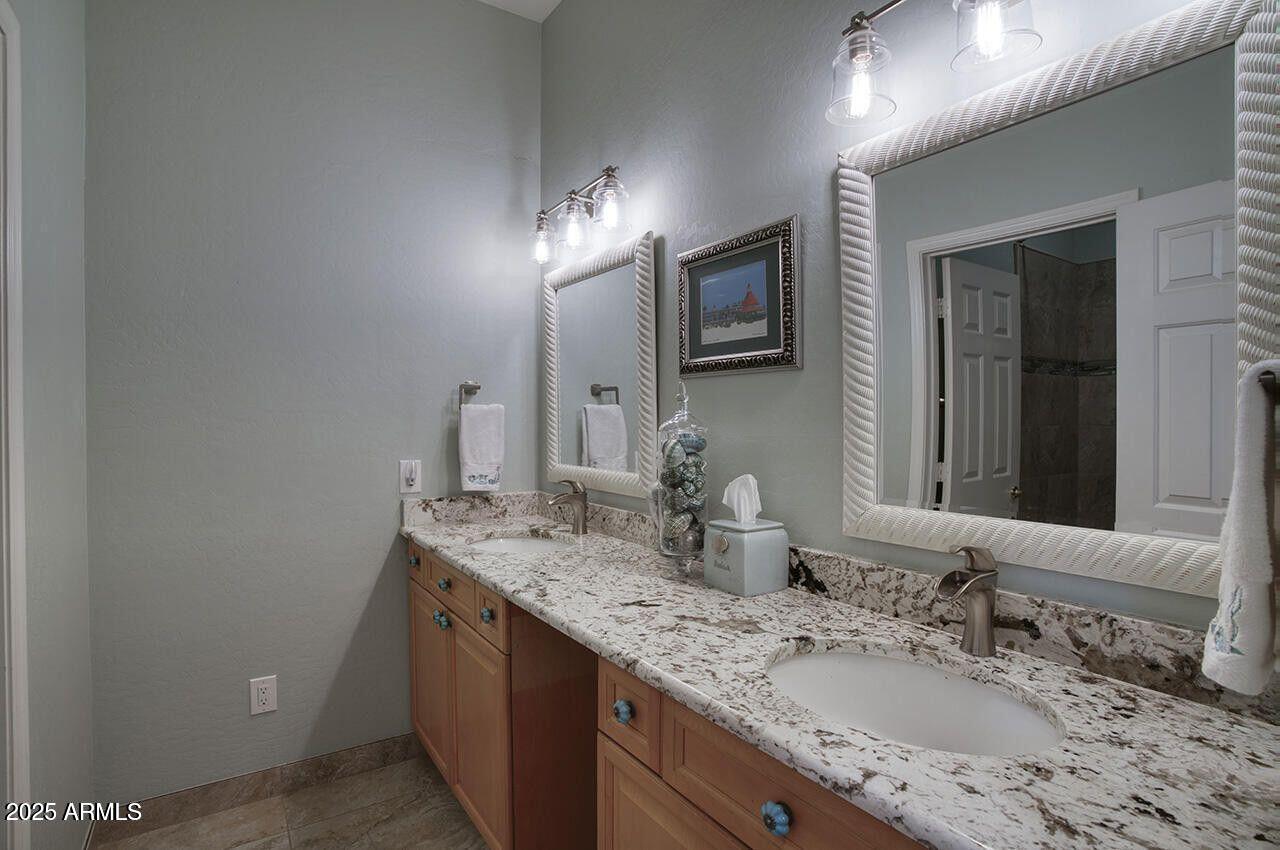 7726 South El Camino Drive Tempe, AZ 85284 - Photo 13 of 17 a bathroom with double sink and a mirror