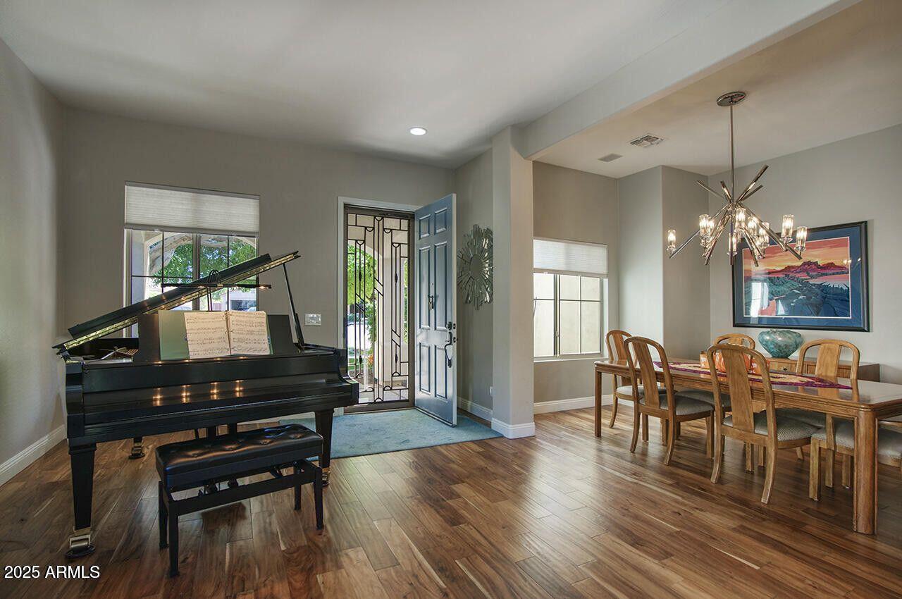 7726 South El Camino Drive Tempe, AZ 85284 - Photo 5 of 17 a living room with furniture a dining table and a piano next to a window