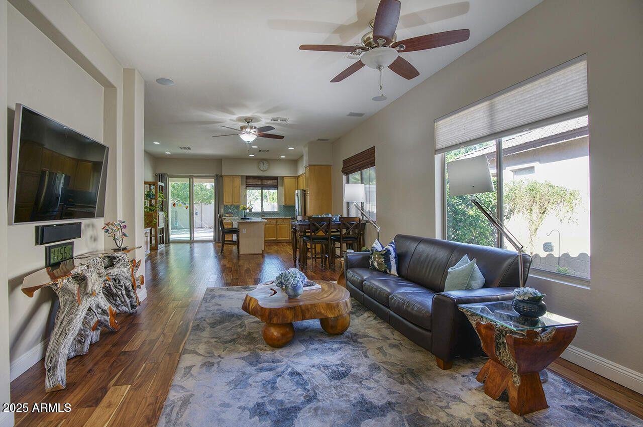 7726 South El Camino Drive Tempe, AZ 85284 - Photo 6 of 17 a living room with furniture a flat screen tv and a large window
