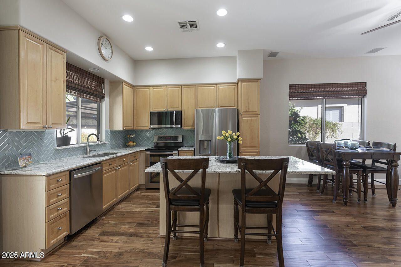 7726 South El Camino Drive Tempe, AZ 85284 - Photo 8 of 17 a large kitchen with a table and chairs