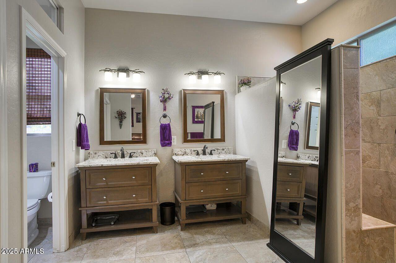 7726 South El Camino Drive Tempe, AZ 85284 - Photo 10 of 17 a bathroom with a double vanity sink mirror and bathtub