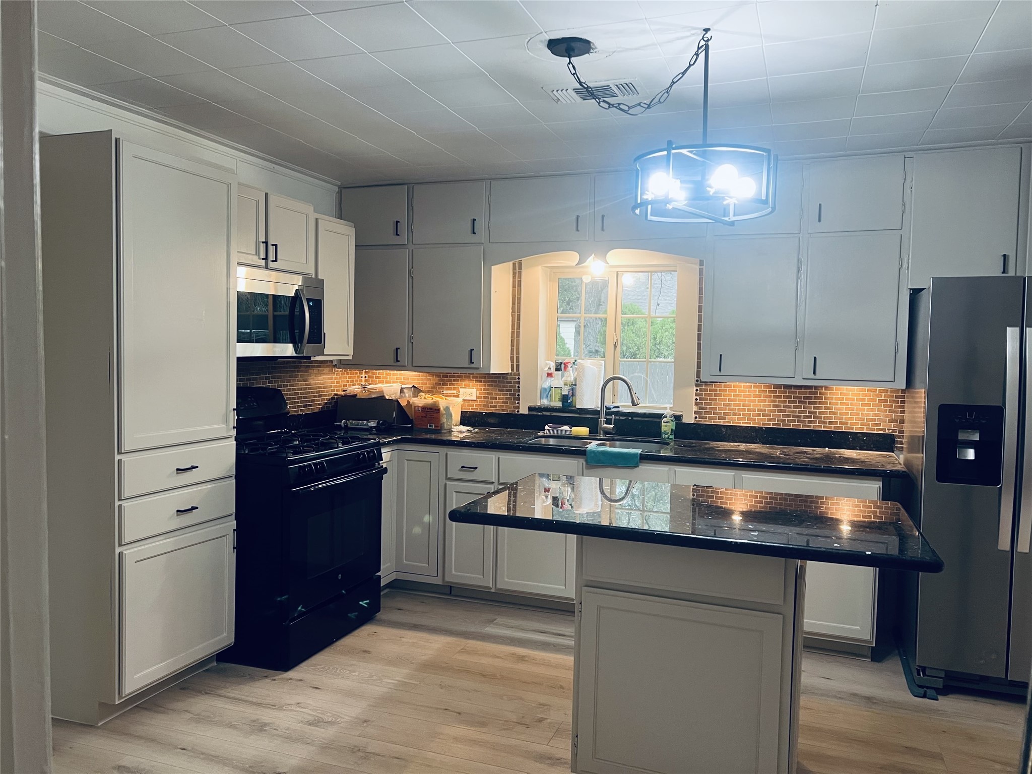 a kitchen with granite countertop stainless steel appliances and wooden cabinets