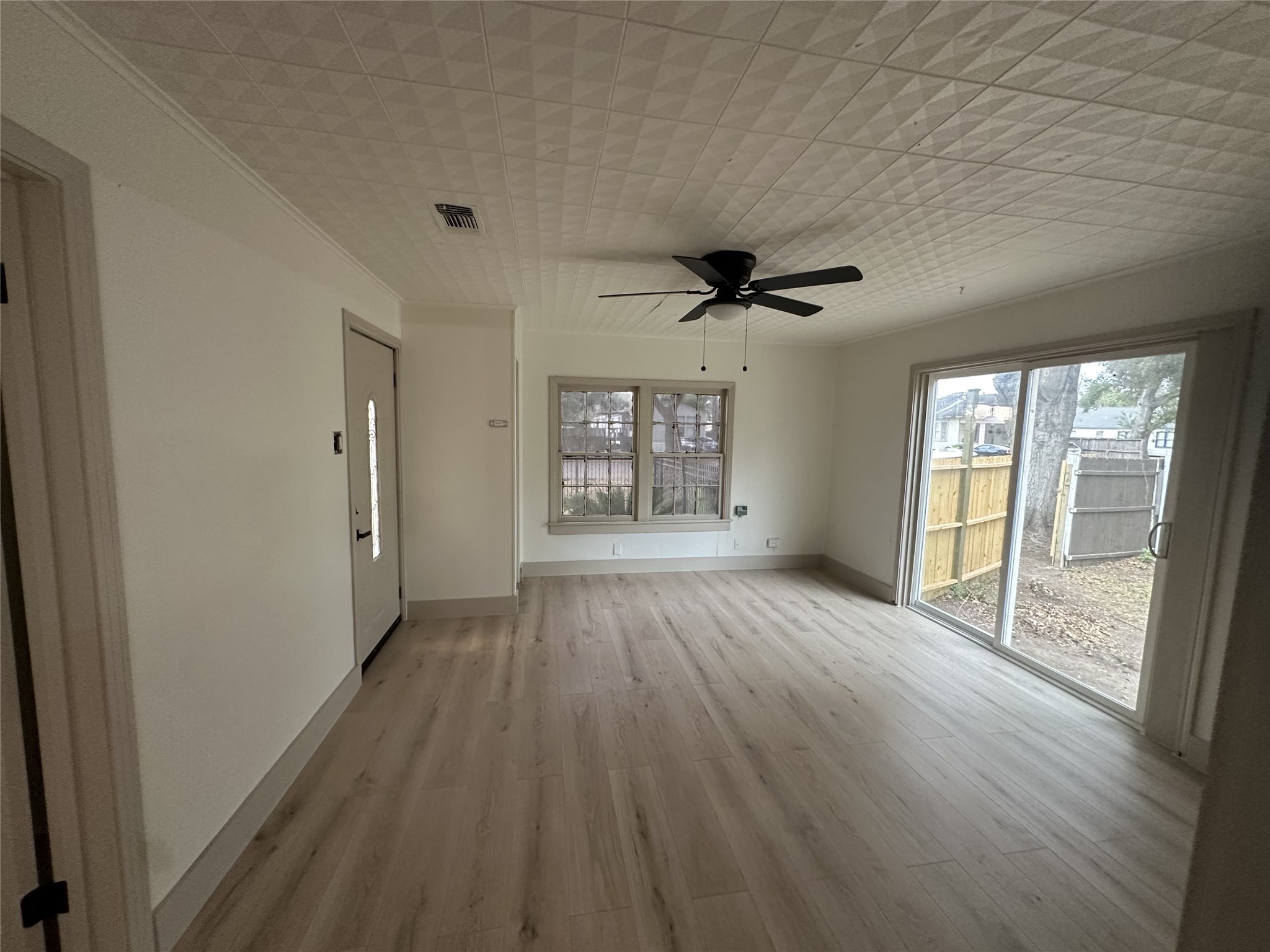 1747 5th Street Rosenberg, TX 77471 - Photo 3 of 10 a view of an empty room with a window and wooden floor