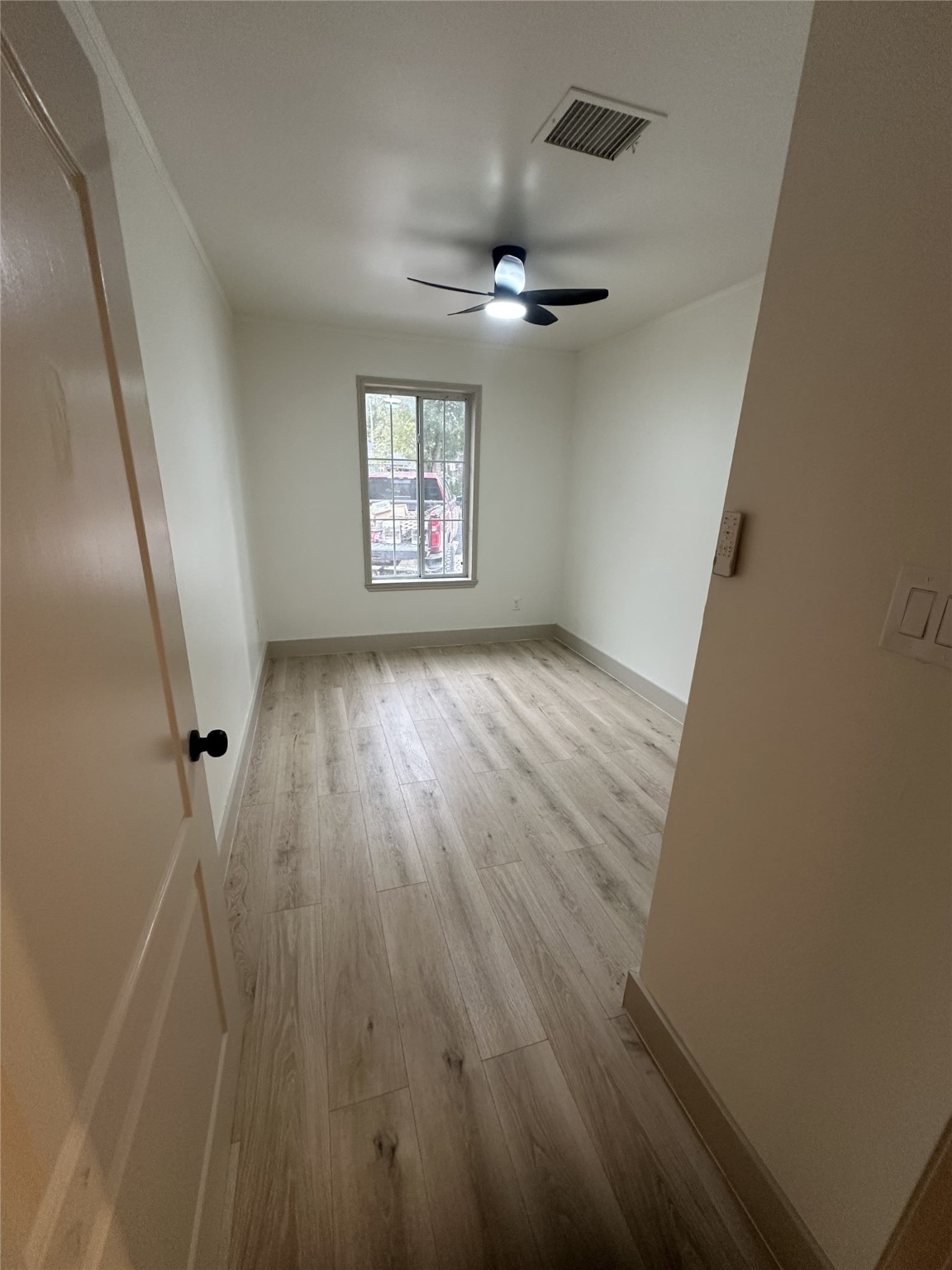 1747 5th Street Rosenberg, TX 77471 - Photo 5 of 10 wooden floor in an empty room with a window