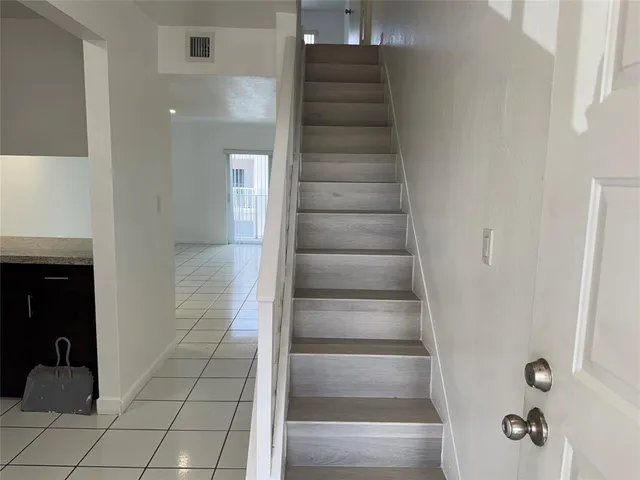 a view of staircase with white walls