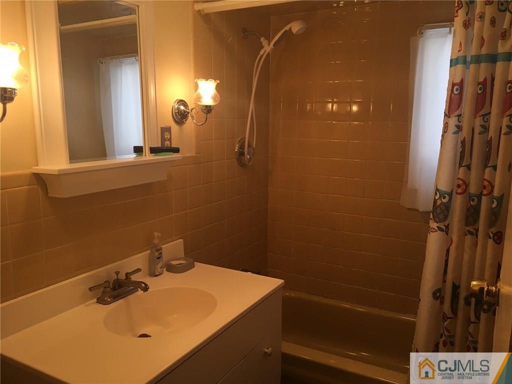 30 Altamont Road Edison, NJ 08817 - Photo 11 of 13 a bathroom with a sink vanity and a mirror