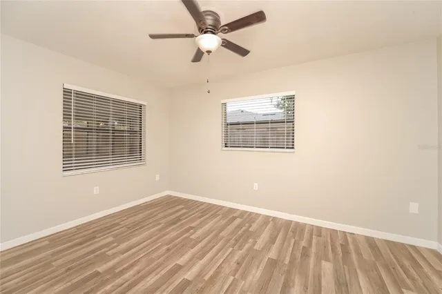 a bathroom with a granite countertop double vanity sink and mirror