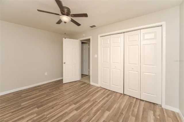 a view of a room with wooden floor and windows