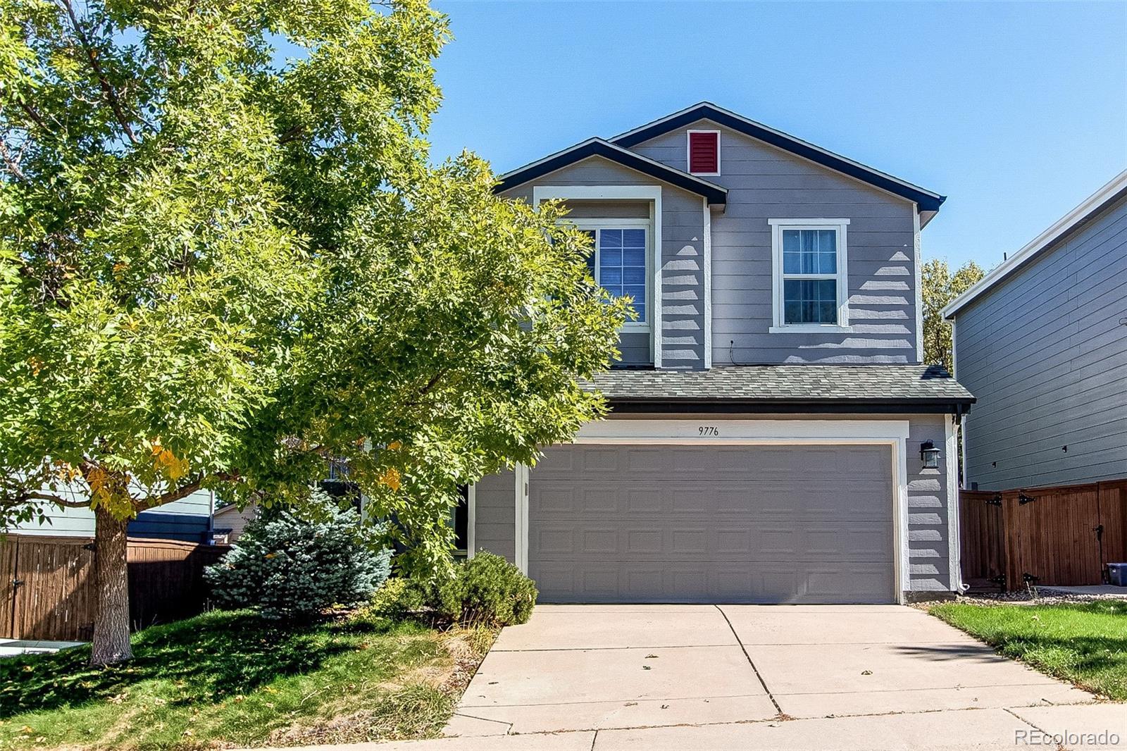 9776 Gatesbury Circle Highlands Ranch, CO 80126 - Photo 1 of 24 a front view of a house with a garden