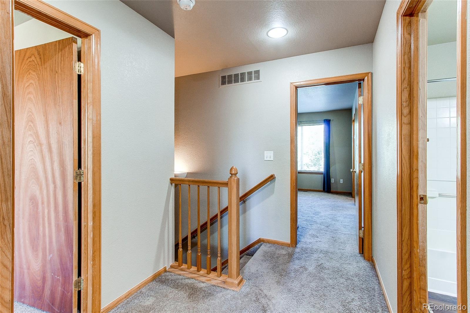 9776 Gatesbury Circle Highlands Ranch, CO 80126 - Photo 12 of 24 a view of a hallway with wooden floor and entryway