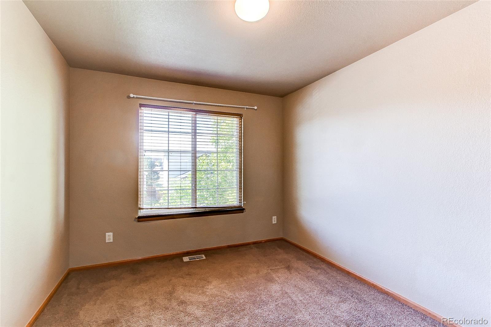 9776 Gatesbury Circle Highlands Ranch, CO 80126 - Photo 17 of 24 an empty room with a window