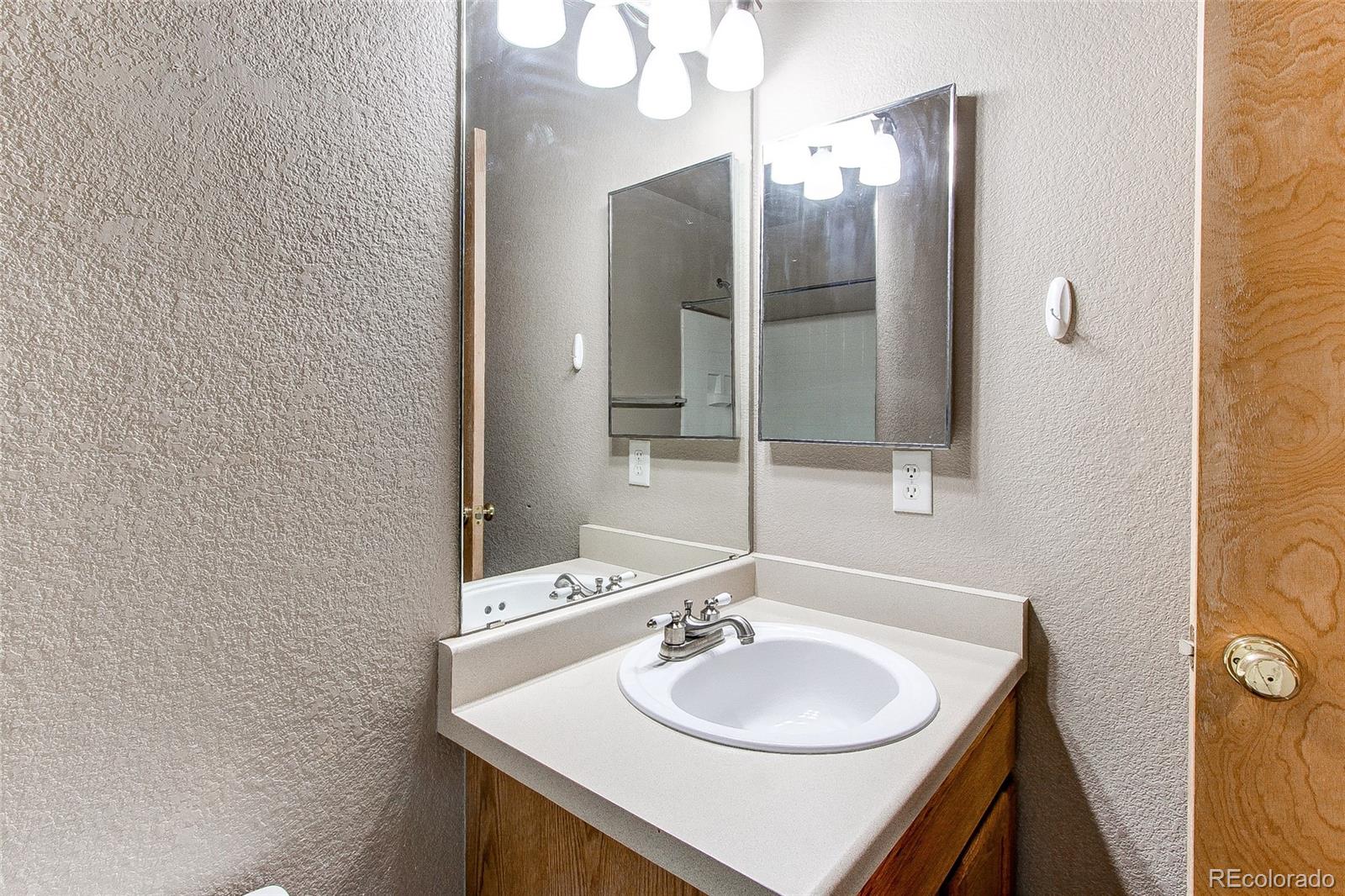 9776 Gatesbury Circle Highlands Ranch, CO 80126 - Photo 19 of 24 a bathroom with a sink and a mirror