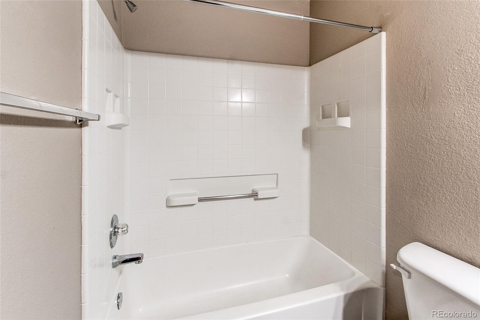 9776 Gatesbury Circle Highlands Ranch, CO 80126 - Photo 20 of 24 a white bath tub sitting next to a toilet