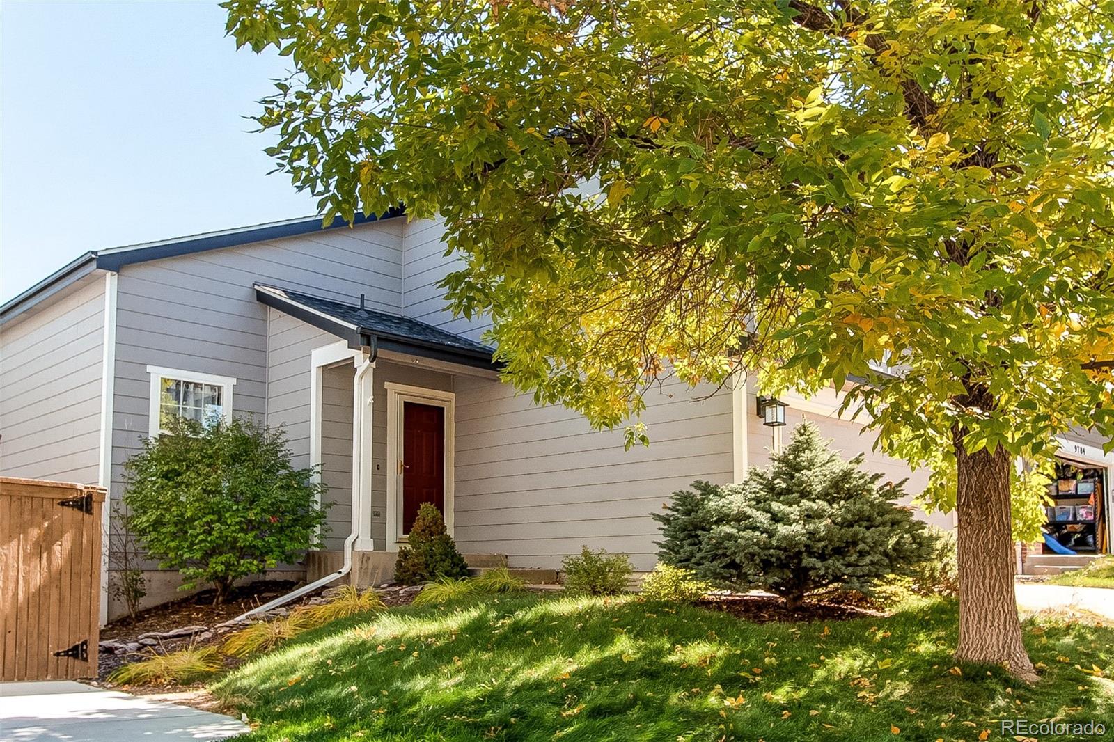 9776 Gatesbury Circle Highlands Ranch, CO 80126 - Photo 2 of 24 a backyard of a house with plants and tree
