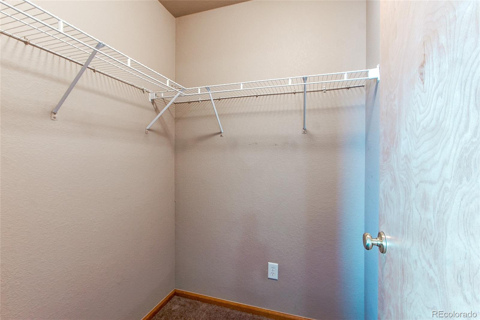 9776 Gatesbury Circle Highlands Ranch, CO 80126 - Photo 22 of 24 a view of a room with racks on the wall