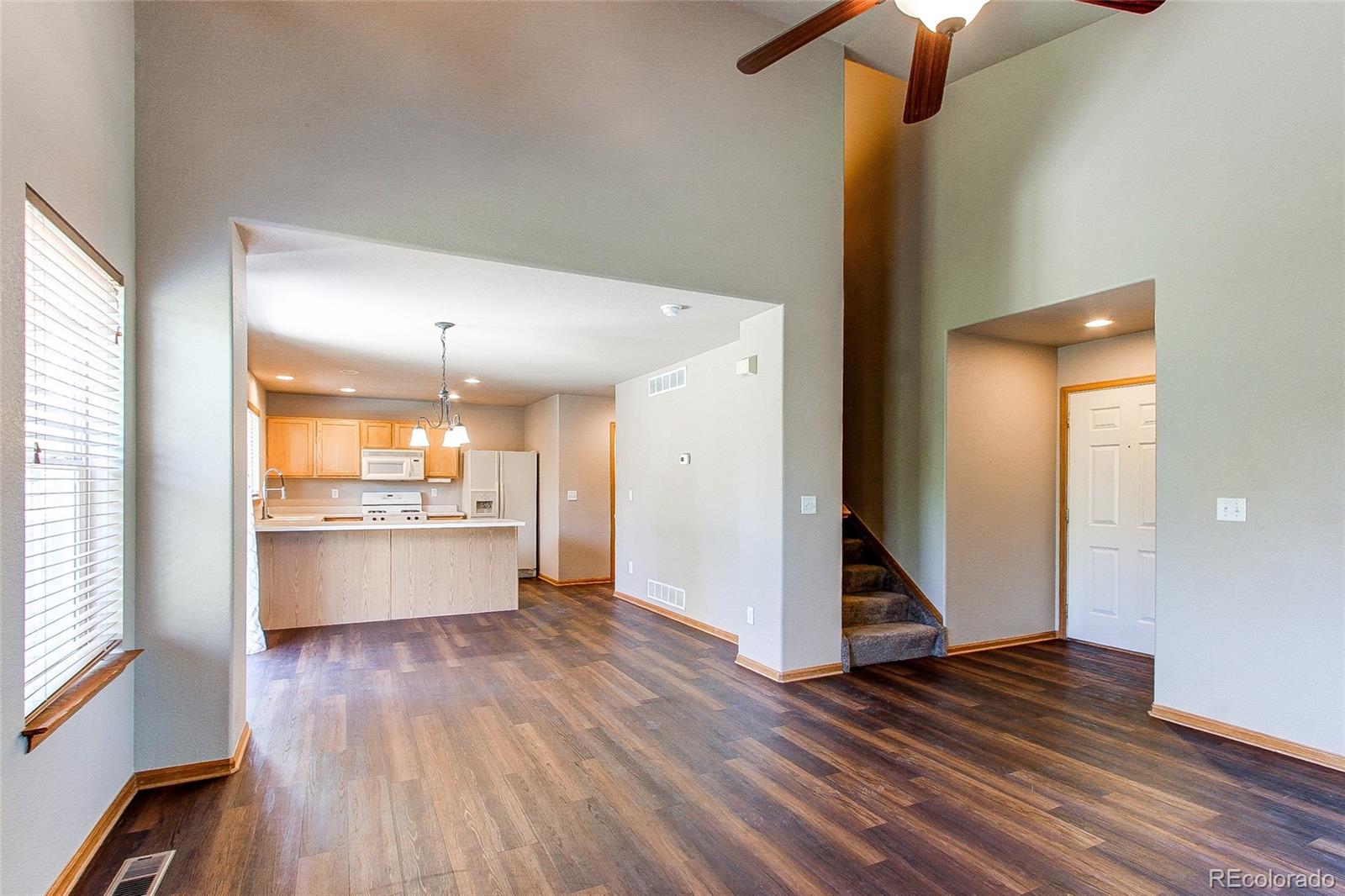 9776 Gatesbury Circle Highlands Ranch, CO 80126 - Photo 5 of 24 a view of a kitchen with wooden floor and a kitchen