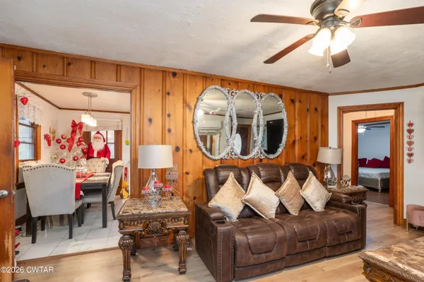 a living room with furniture a fireplace and a chandelier