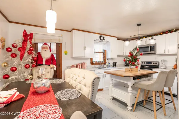 a view of kitchen island with furniture and appliances