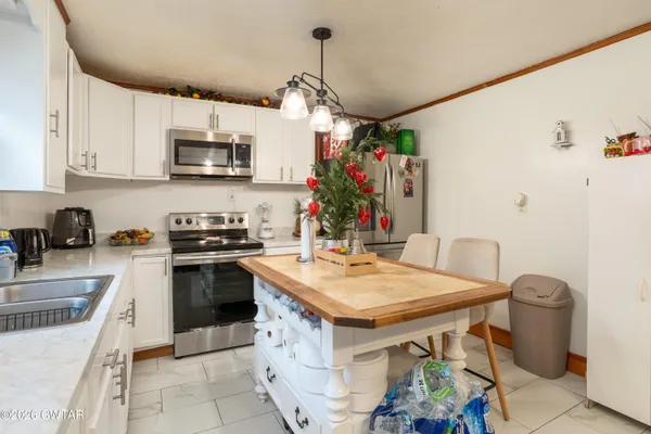 a kitchen with stainless steel appliances granite countertop a sink and a stove
