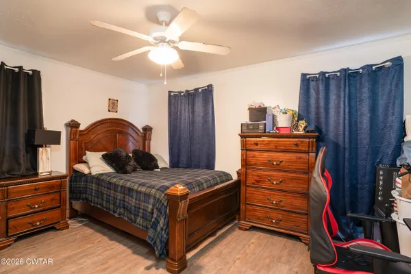 a bedroom with a bed and a dresser