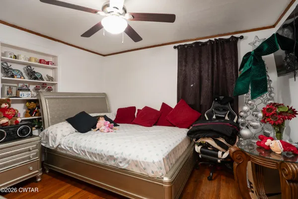 a bedroom with bed and a chandelier