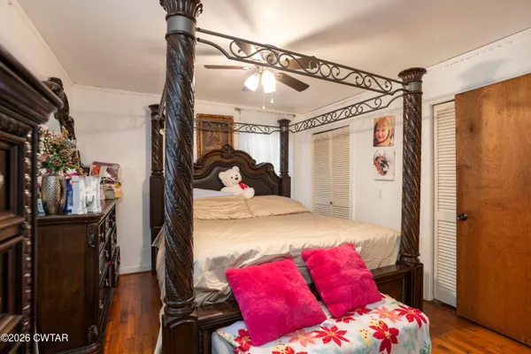 a bathroom with a granite countertop bathtub sink vanity mirror and toilet