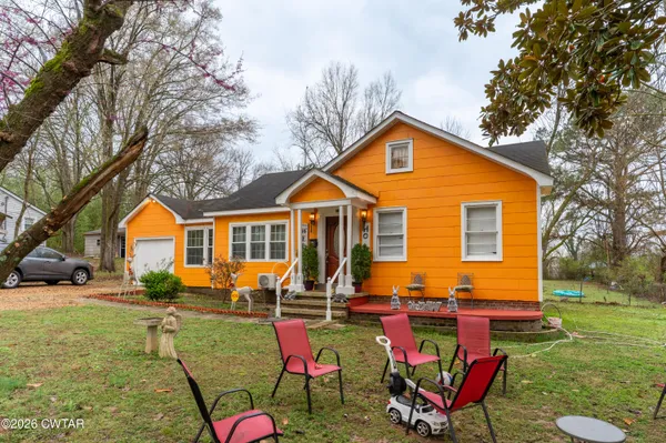 a front view of house with yard and outdoor seating