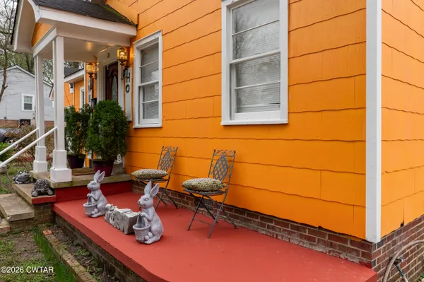 a outdoor space with the couches and a potted plant on the wall