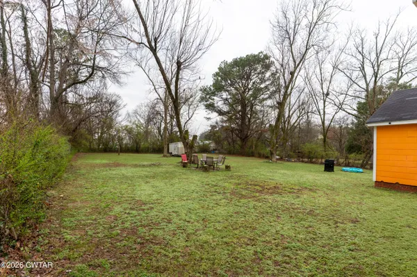 a view of a field with trees