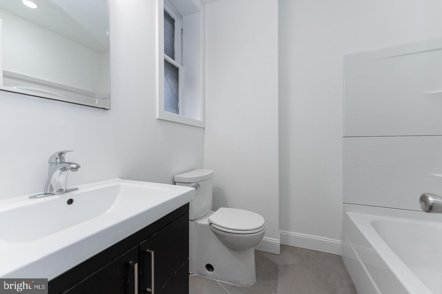 2118 Spruce Street, Unit 2R Philadelphia, PA 19103 - Photo 18 of 25 a bathroom with a sink a toilet and bathtub