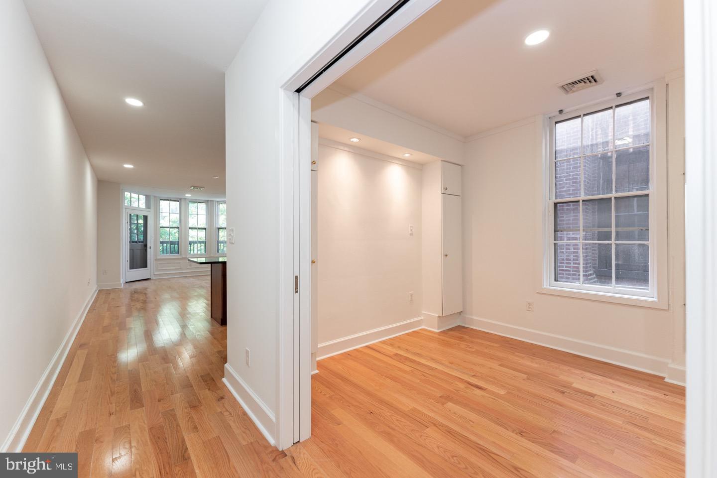 2118 Spruce Street, Unit 2R Philadelphia, PA 19103 - Photo 19 of 25 an empty room with wooden floor and windows