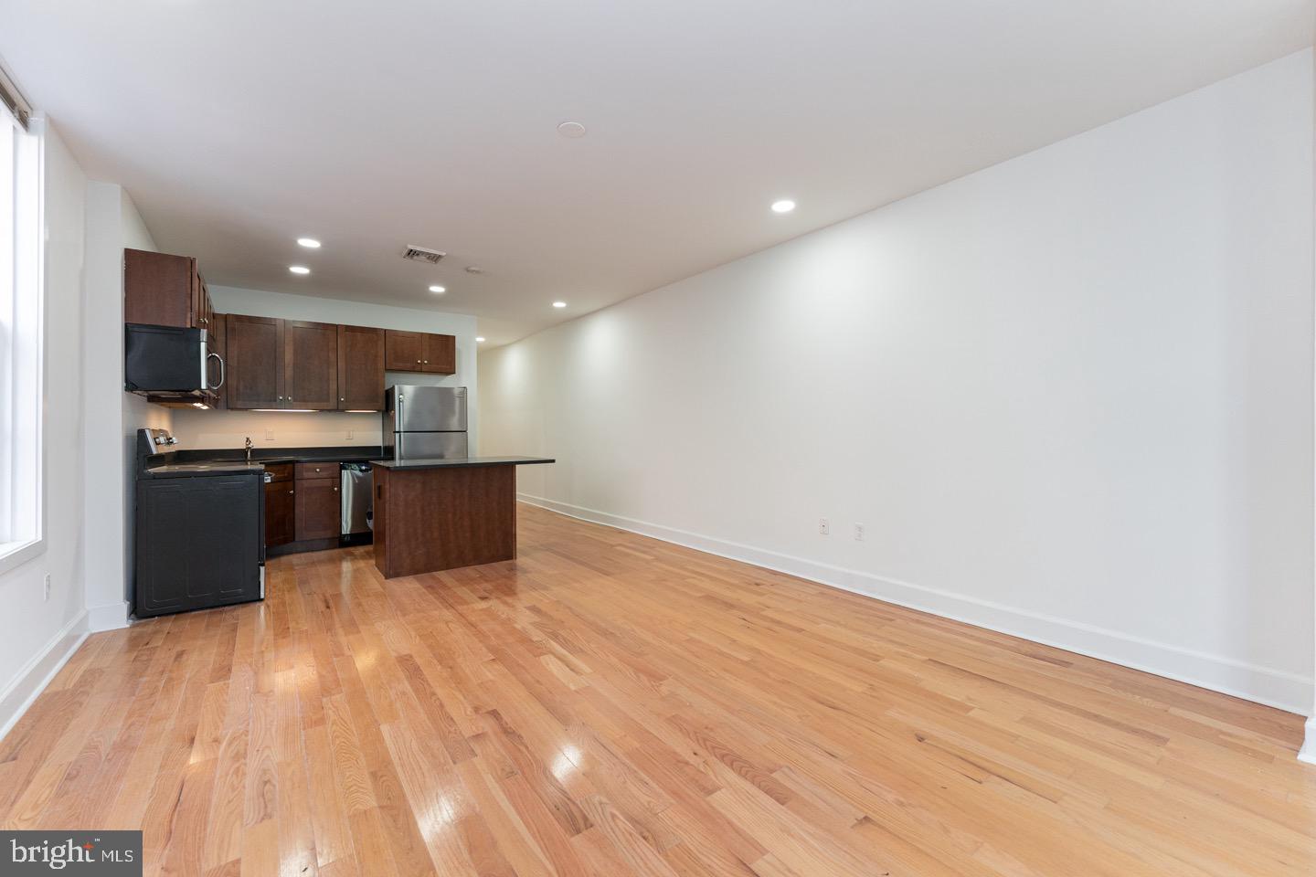 2118 Spruce Street, Unit 2R Philadelphia, PA 19103 - Photo 6 of 25 a view of kitchen with kitchen island microwave and cabinets