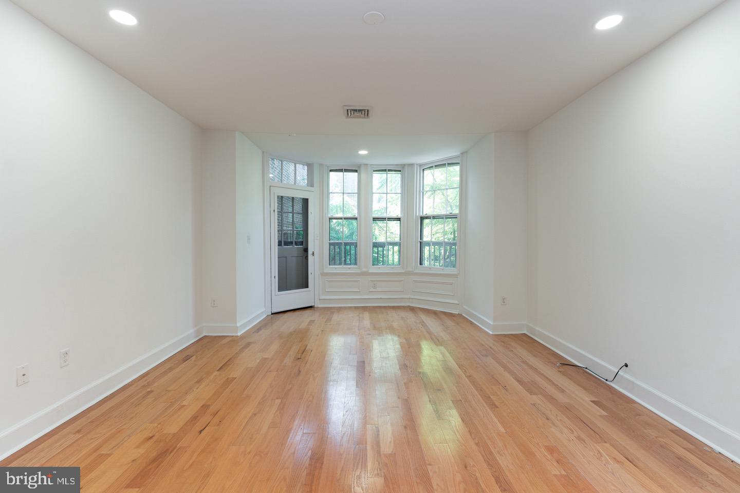 2118 Spruce Street, Unit 2R Philadelphia, PA 19103 - Photo 10 of 25 wooden floor in an empty room with a window