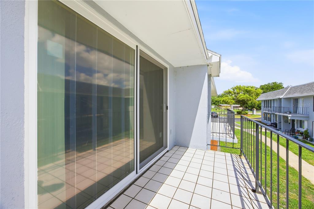 925 West Oak Ridge Road, Unit 925C Orlando, FL 32809 - Photo 12 of 15 a view of balcony with wooden floor